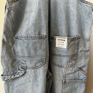 Distressed denim overalls